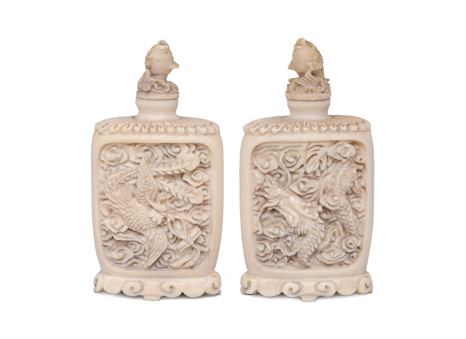 A pair of fine ivory snuffbottles with dragon and phoenix