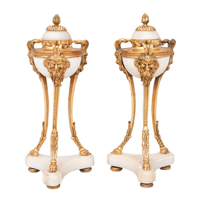 A pair of small bronze alabaster tripods with empire ornaments