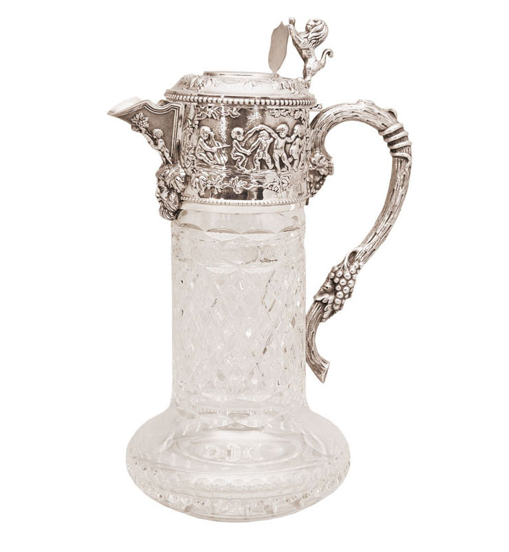 A glass decanter with putti decoration and Bacchus scenery