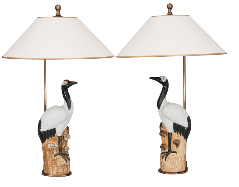 A pair of lamps with crane figures