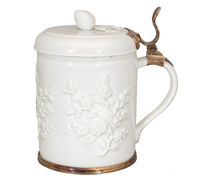 An armorial tankard with flower relief