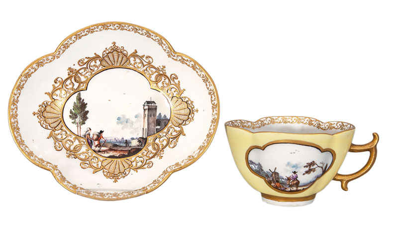 A yellow-ground cup and saucer with Kauffahrtei- and landscape scenes