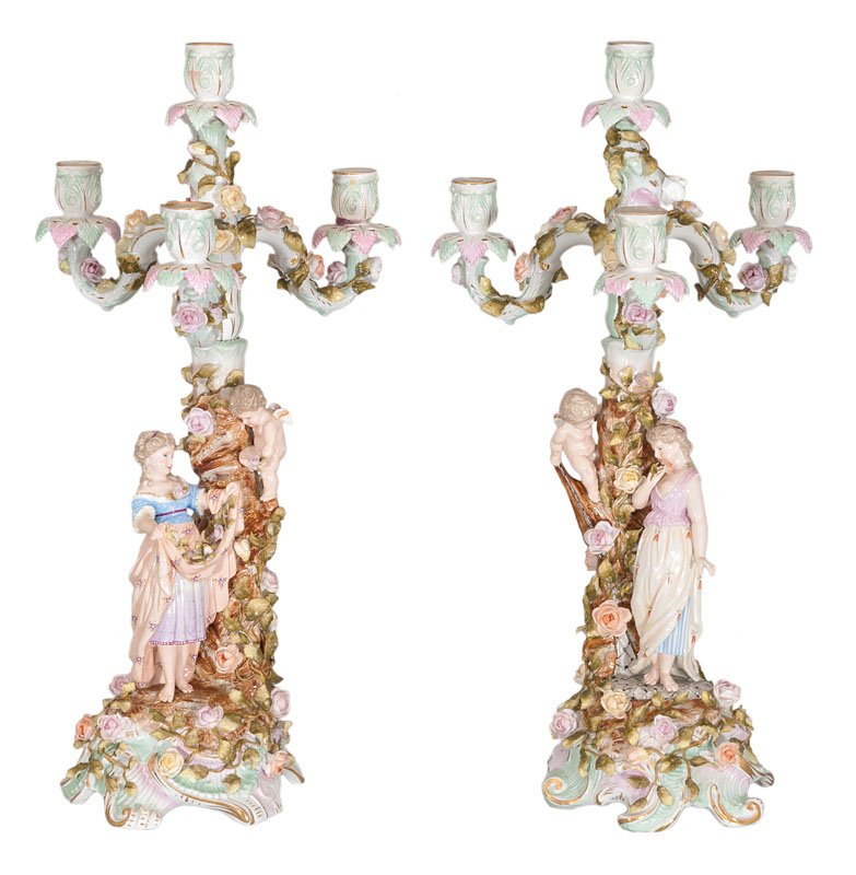 A pair of tall candelabra with allegorical figures