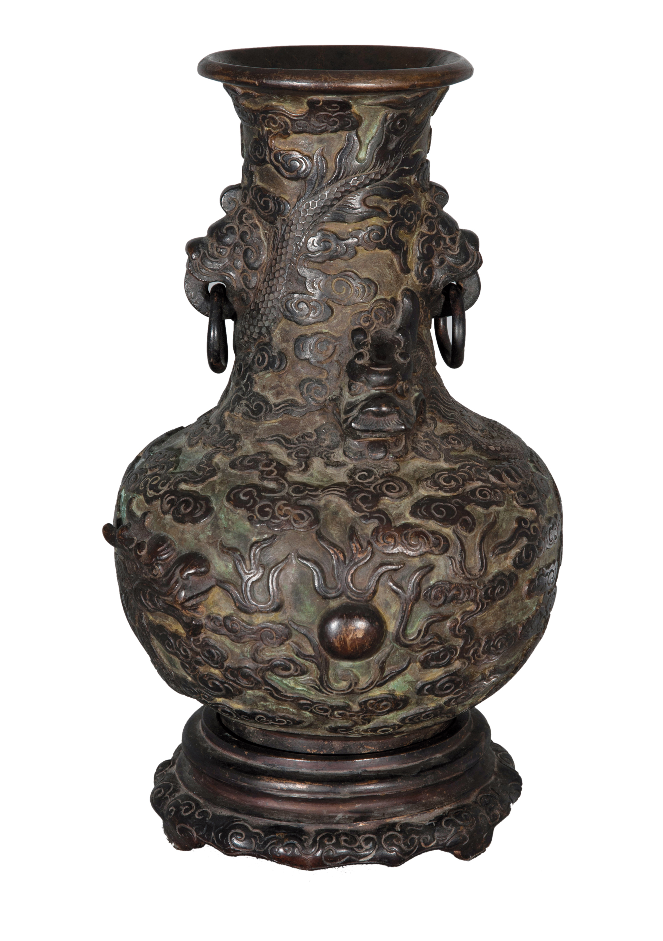 A bronze vase with dragon relief