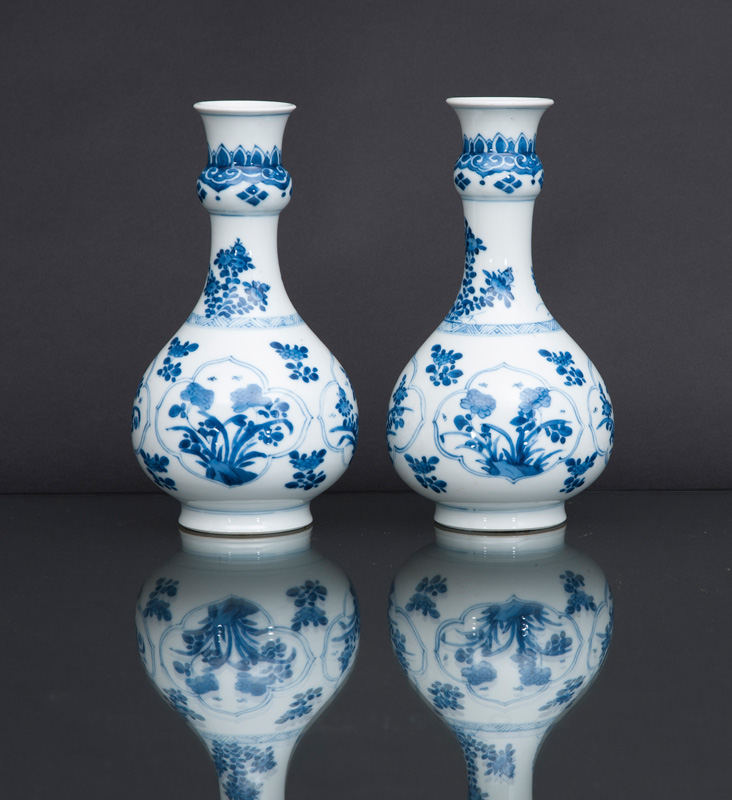 A pair of small bottle vases with flower decoration