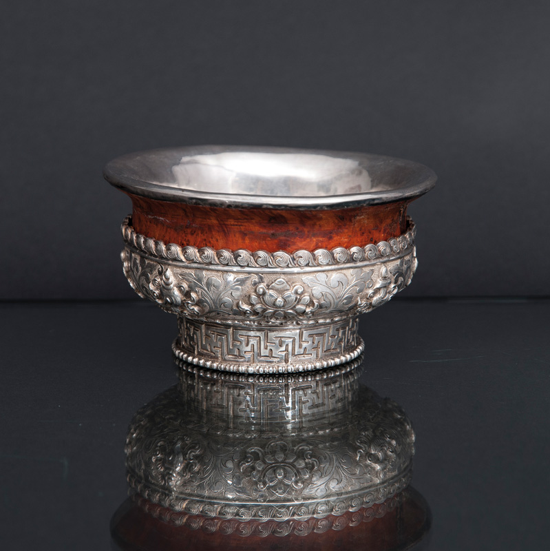 An offering bowl with buddhist symbols