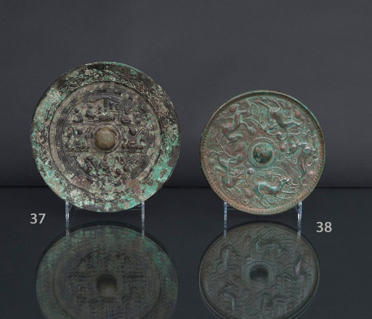 A bronze mirror with mythological figures and creatures