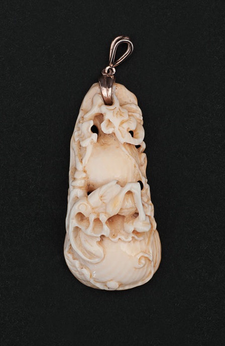 An antique ivory 'Grasshopper' as a pendant