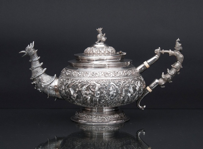 A fine silver repoussé teapot with sumptuous relief decoration