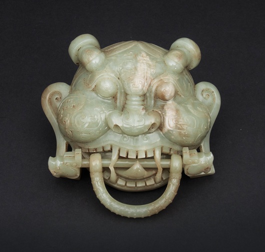 A highly unusual jade mask in the shape of a door knocker