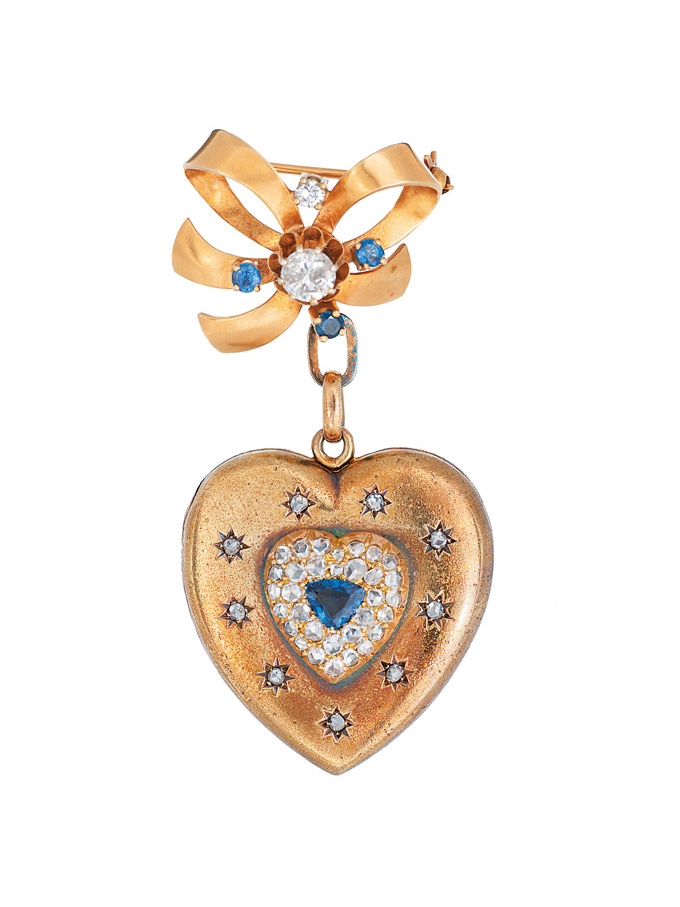 A heart shaped medaillon with diamonds and sapphires and brooch
