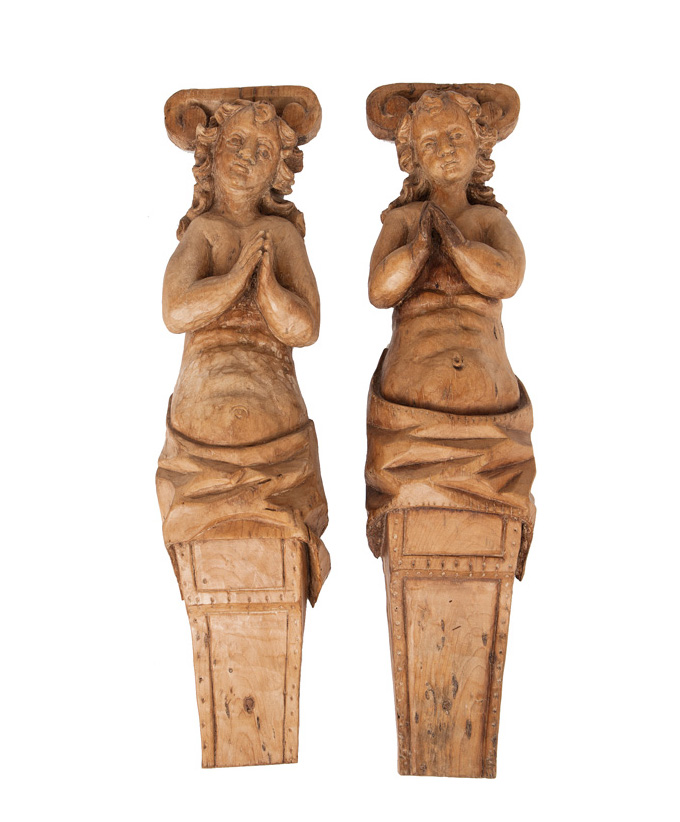 A pair of wooden relief figures