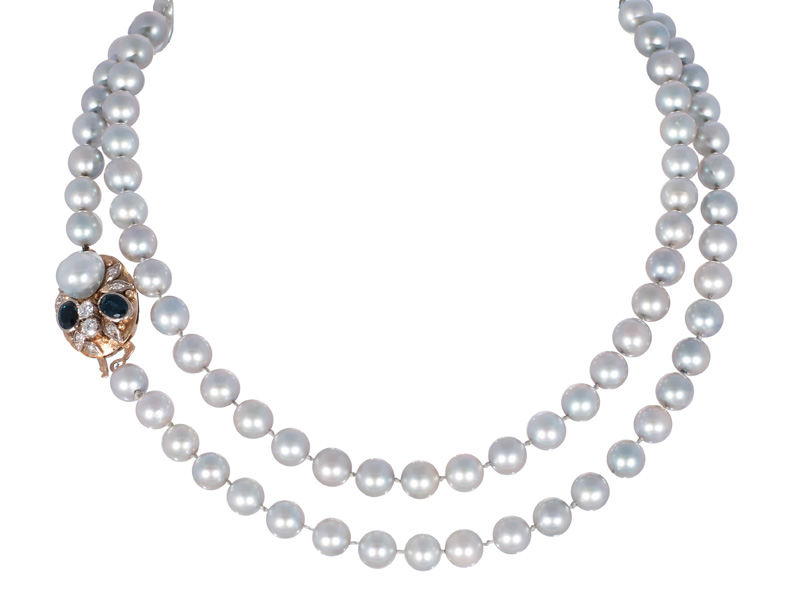 A long pearl necklace with sapphire diamond clasp