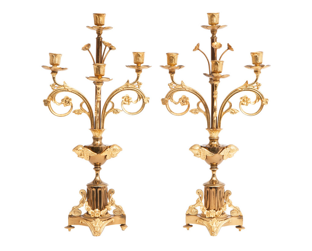 A pair of candelaber with cherubim