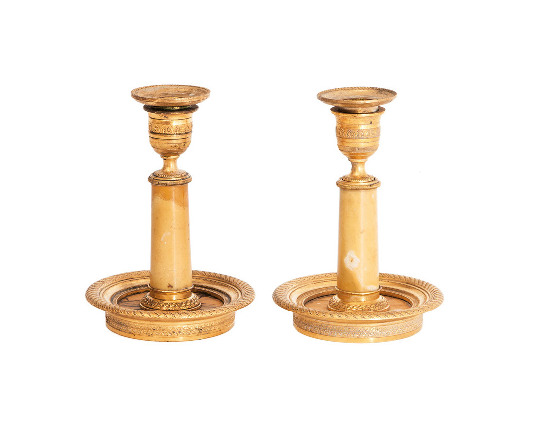 A pair of fire gilded Empire candlesticks
