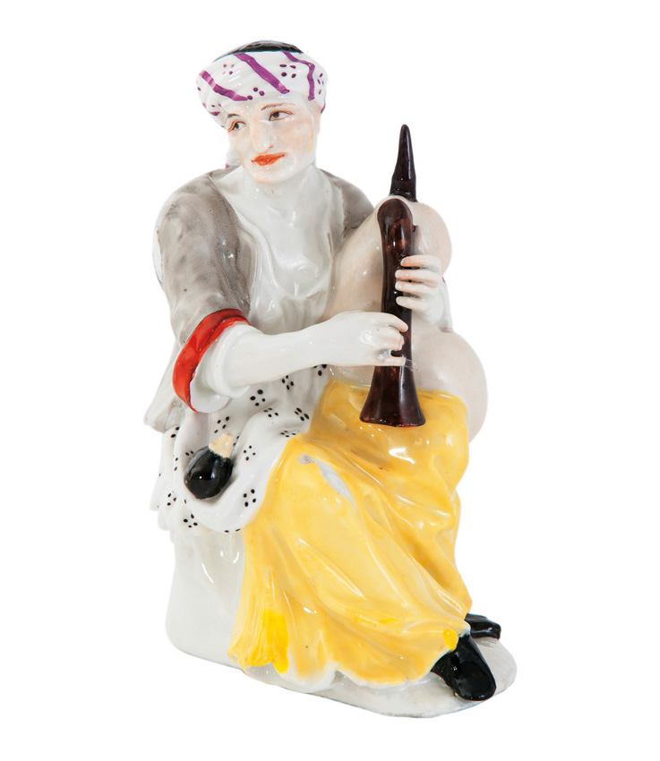 A figure 'Beggar woman with bagpipe'