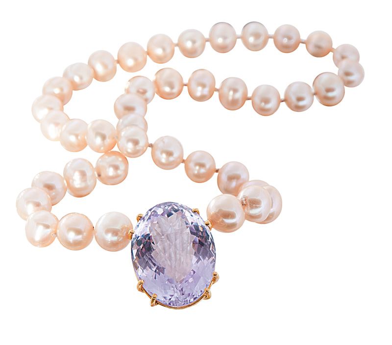 A pearl necklace with amethyst clasp
