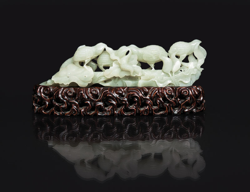 A fine white jade carving with quails and lotus plants