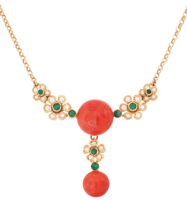 A petite coral necklace with diamonds and emeralds
