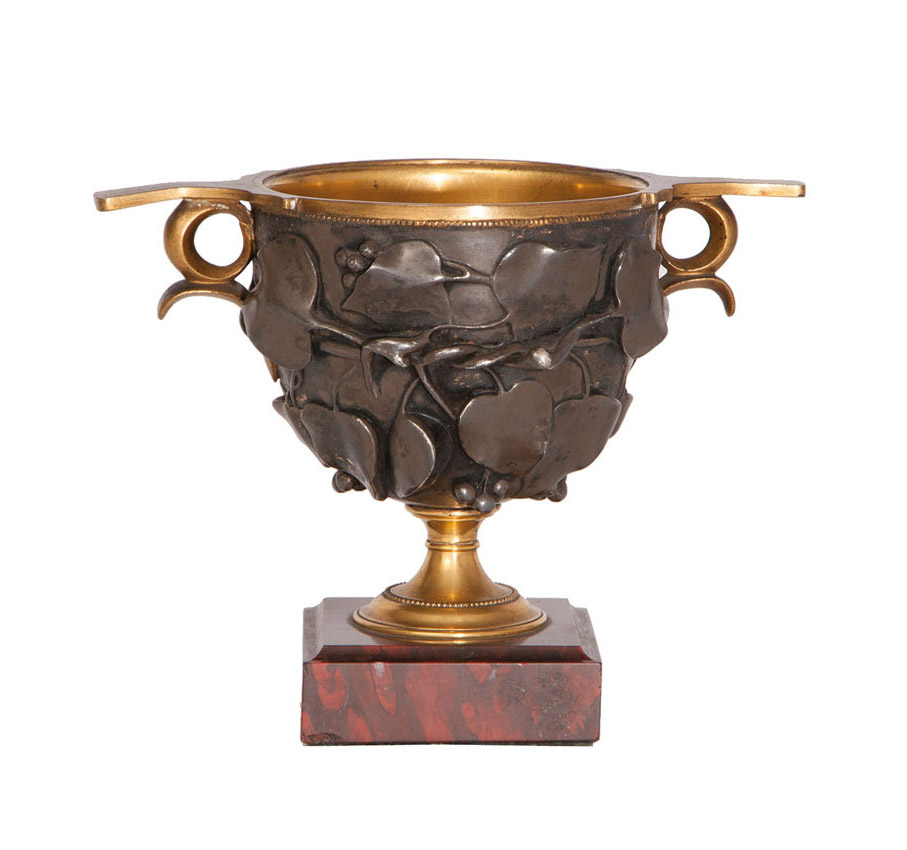 An elegant bronze amphora vase with foliage