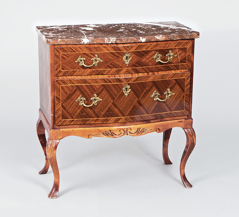 A small chest of drawers in the style of Baroque