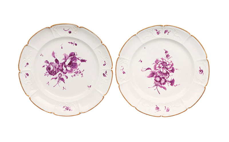 A pair of plates with purple flower bouquets