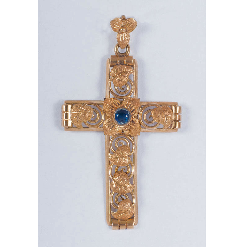 A golden cross shaped pendant