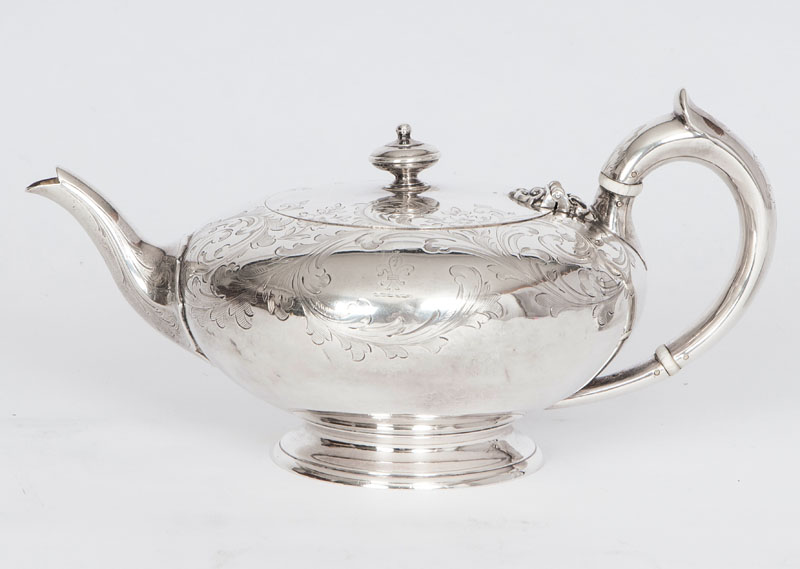 A Victorian tea pot with floral engraved pattern