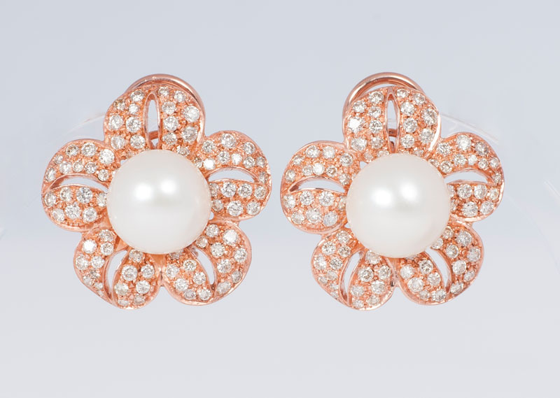 A pair of pearl diamond earrings
