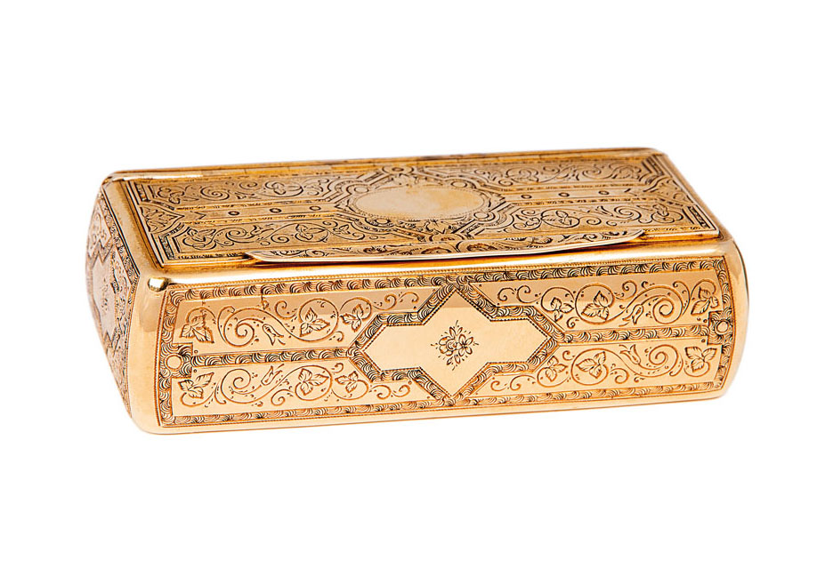 A gold box with fine engraved pattern
