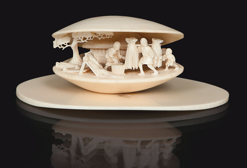 An ivory netsuke 'Clam with miniature carving'