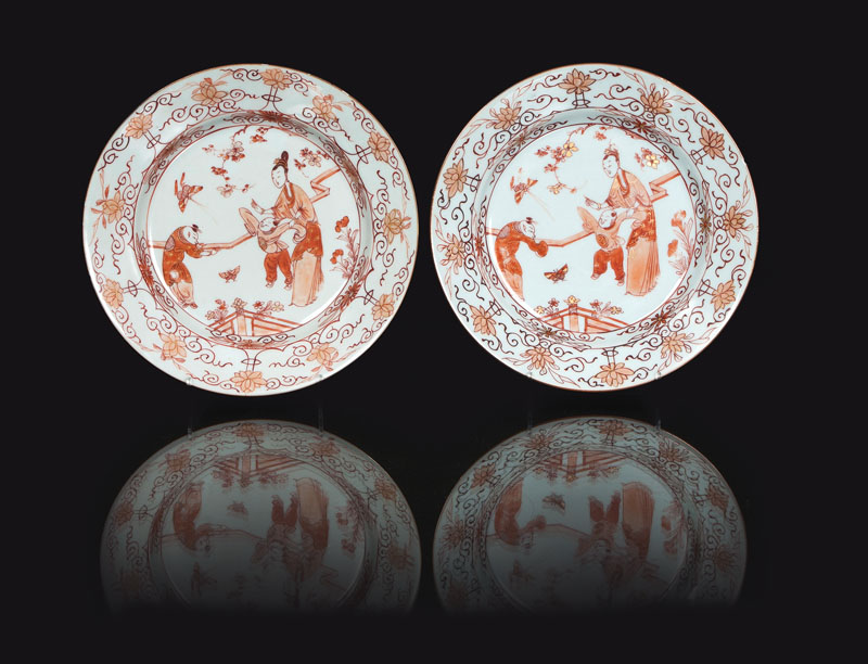 A pair of plates with garden scene