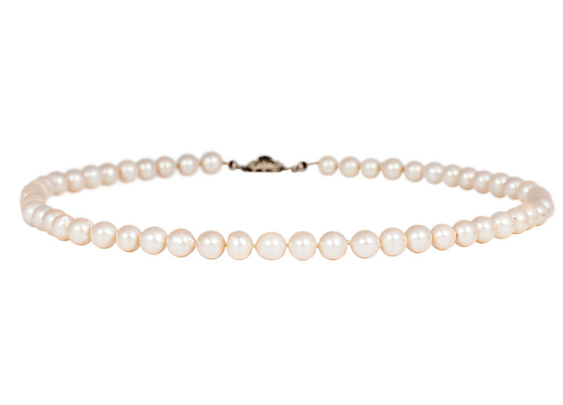 A pearl necklace with small sapphire clasp