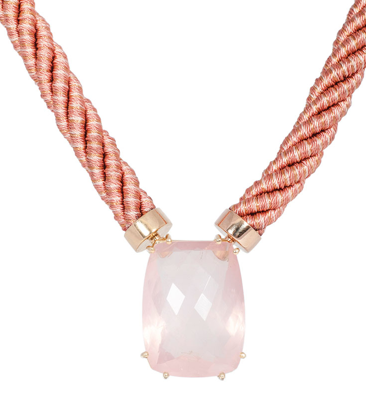 A large rose quartz pendant with silk necklace