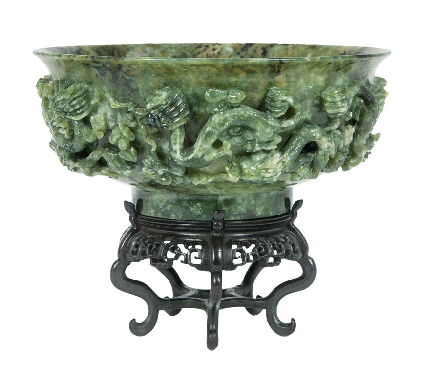 A large spinach green jade bowl with dragon decor