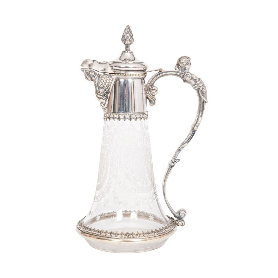 A glass decanter with silver-plated mounting