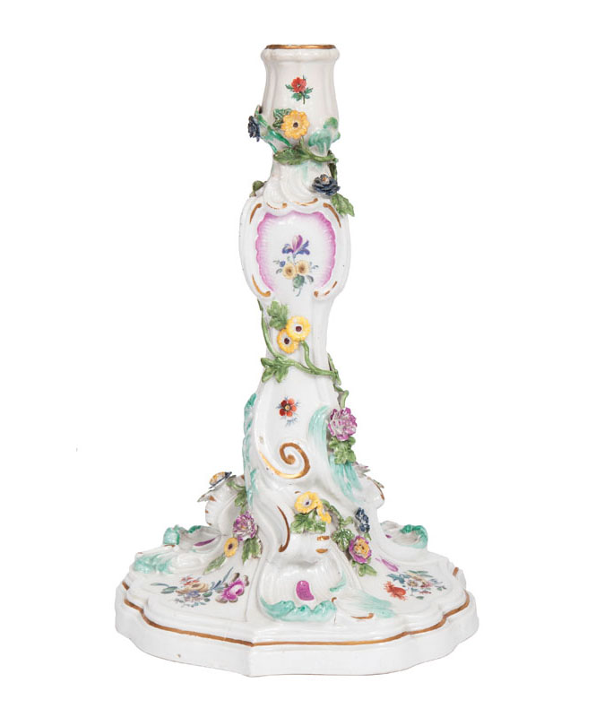 A candlestick with sculptural floral decoration