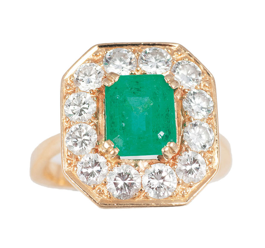 A ring with diamonds and one green glass stones