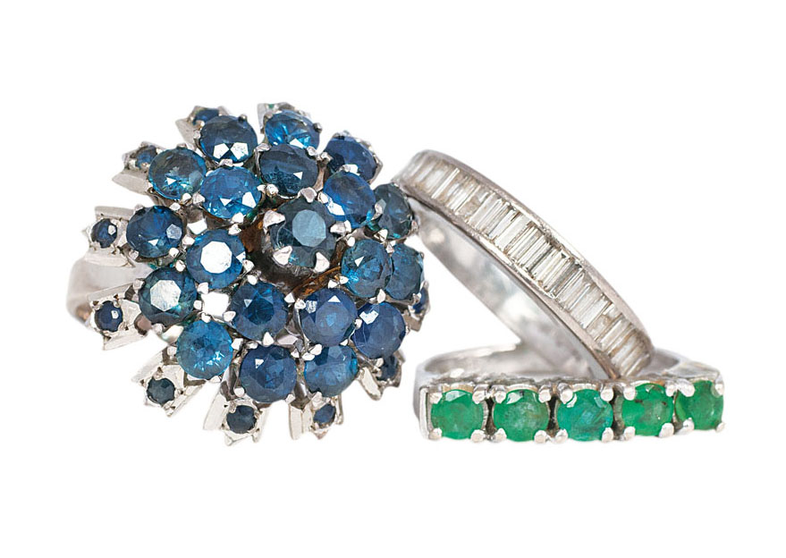 A set of 3 rings with diamonds, sappires and emeralds