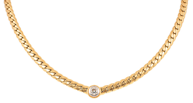 A golden necklace with one diamond