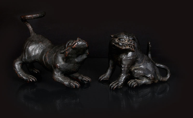 A pair of bronze mythical beasts