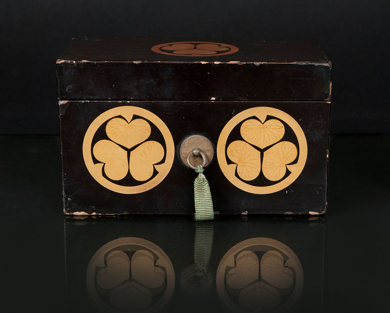 A small lacquered box with crest