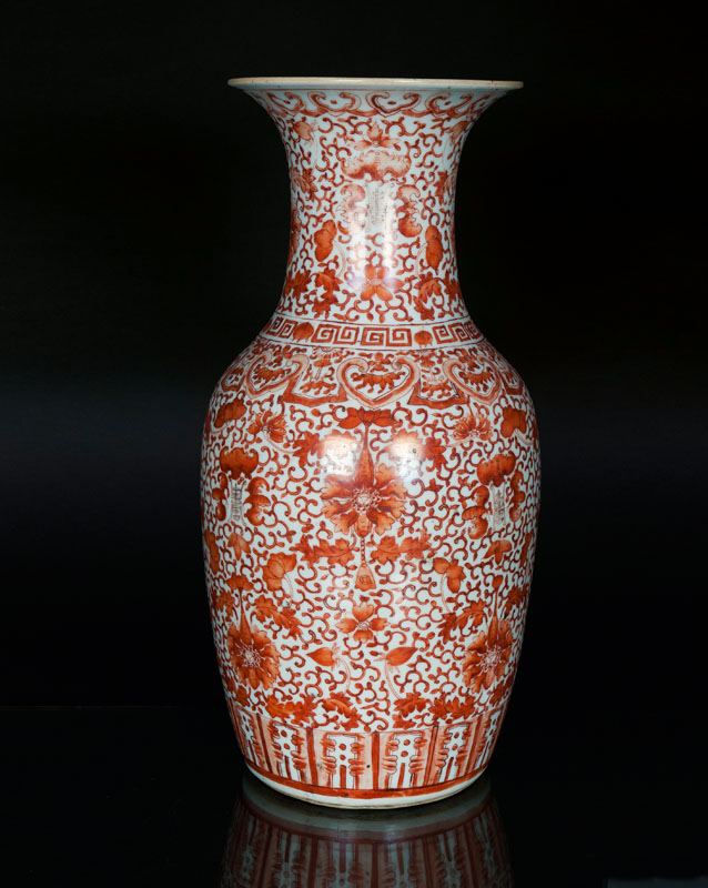 A large iron-red vase with auspicious symbols