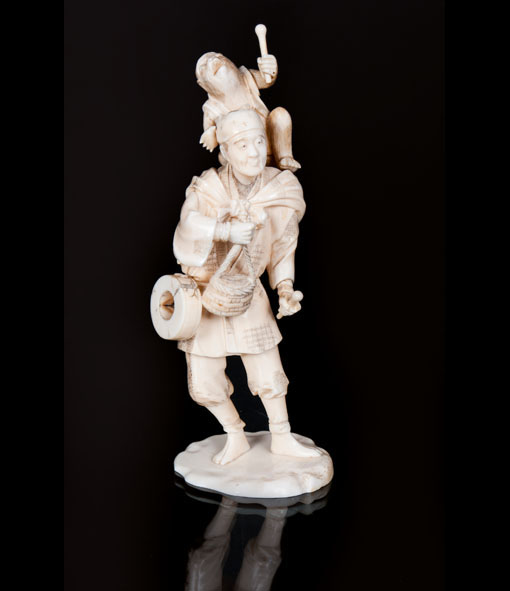 An ivory okimono 'Peasant with monkey'