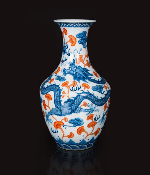 A blue and iron-red vase with dragon decor