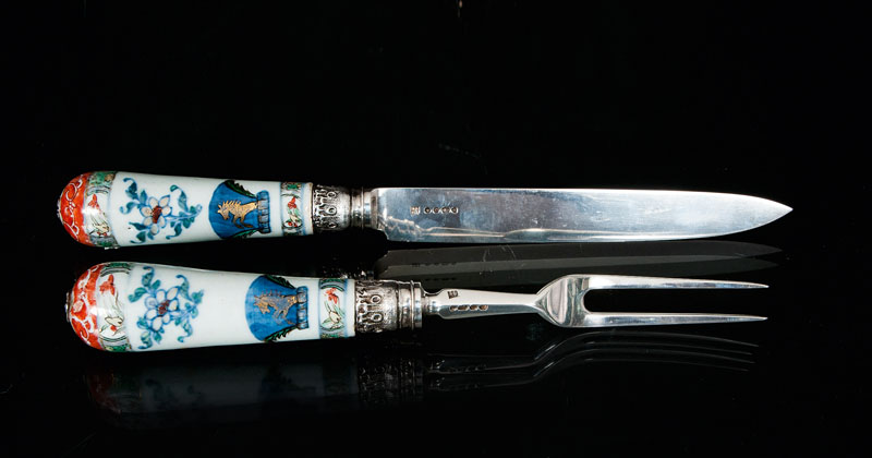 A pair of carvers with porcelain handles