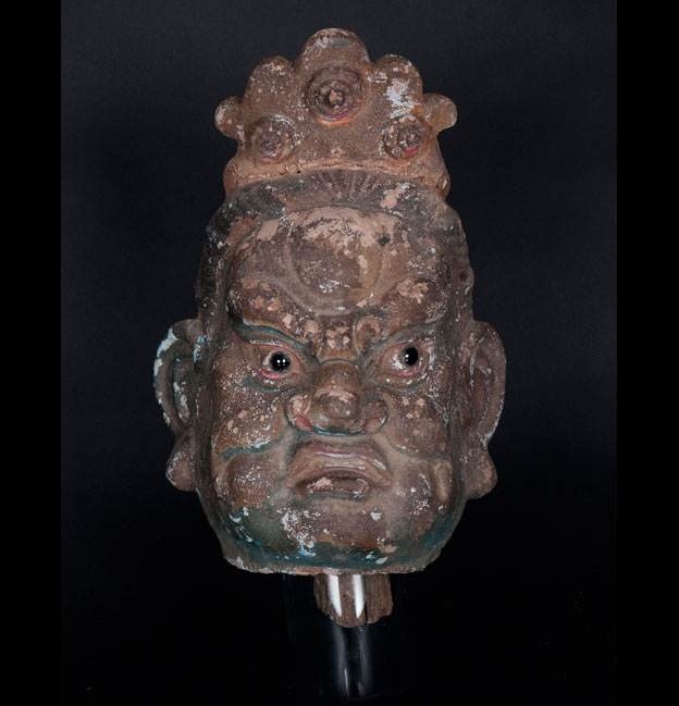 A pottery head of a temple guardian