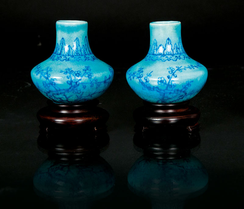 A pair of turquoise ground miniature vases
