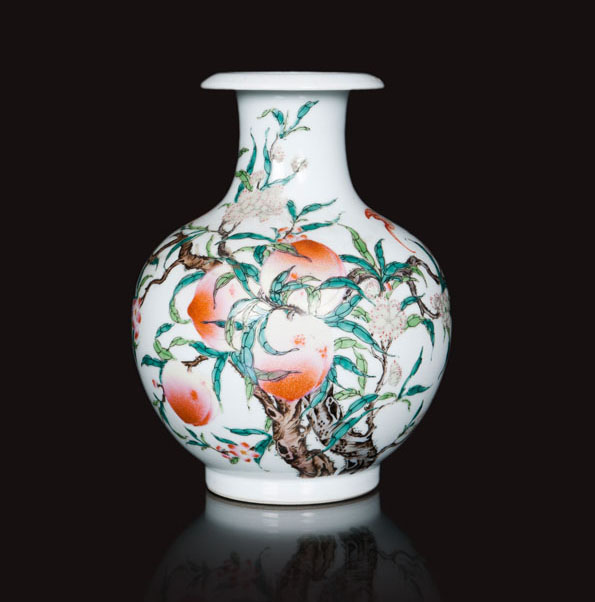 A vase with peaches and bats