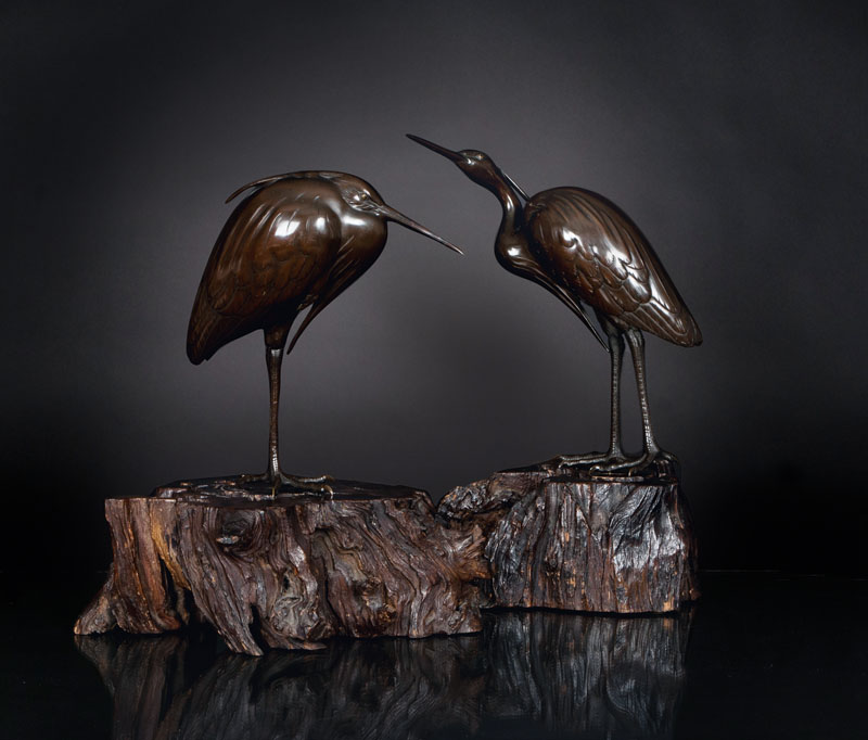 A pair of excellent heron bronze figures